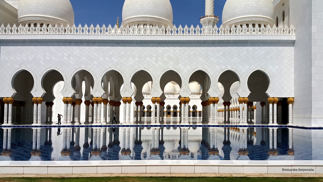 Arches mirrored in the pools around the mosque